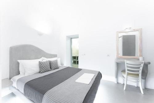 a bedroom with a bed and a desk and a mirror at Cooper's Cave house with heated Jacuzzi in Megalokhori