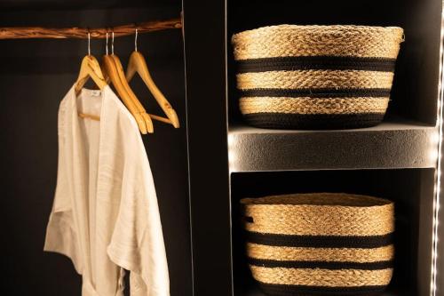 two stacks of towels and baskets in a closet at Cooper's Cave house with heated Jacuzzi in Megalokhori