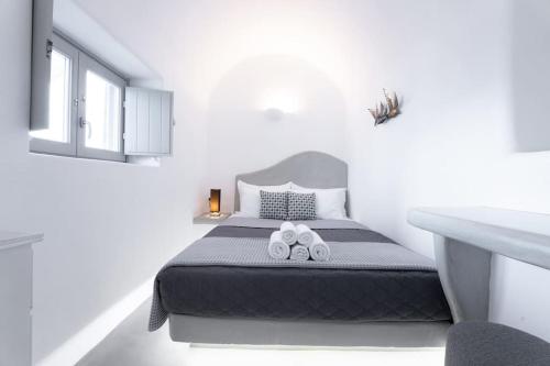 a bedroom with a bed with two slippers on it at Cooper's Cave house with heated Jacuzzi in Megalokhori