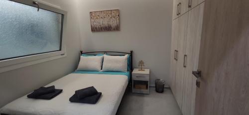 a small bedroom with a bed and a window at Rofos Residence in Elounda