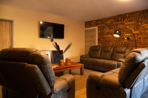 a living room with two chairs and a couch at Melamar Estate in Marloth Park