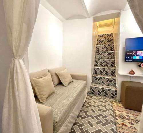 a living room with a couch and a tv at City Center, Special Cosy Home in Tangier