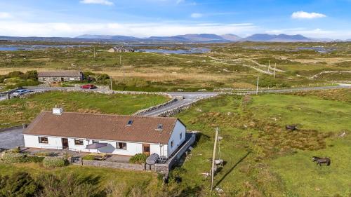 an aerial view of a house in a field at Little Tara, Ballyconneely in Ballyconneely