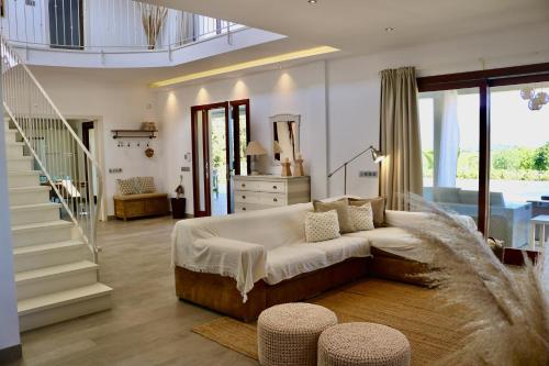 a bedroom with a large bed and a staircase at Can Mutxo in Biniamar