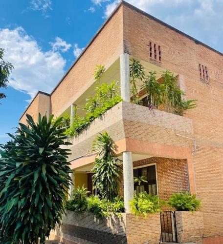 a brick building with plants on top of it at KWEZI S Apartments in Bujumbura
