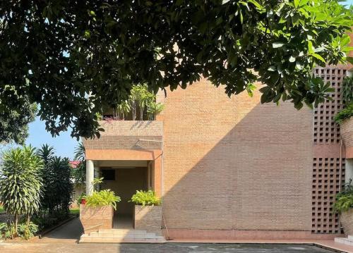 a brick building with a door and some plants at KWEZI S Apartments in Bujumbura