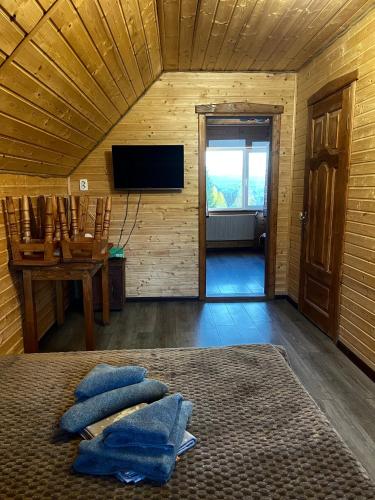 a room with a bed with blue pillows on it at Khatky Na Penkakh in Vorokhta