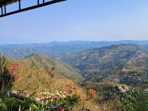a view of a valley with mountains in the background at Dormitories/Hosteller, Giftland Homestay in Āīzawl