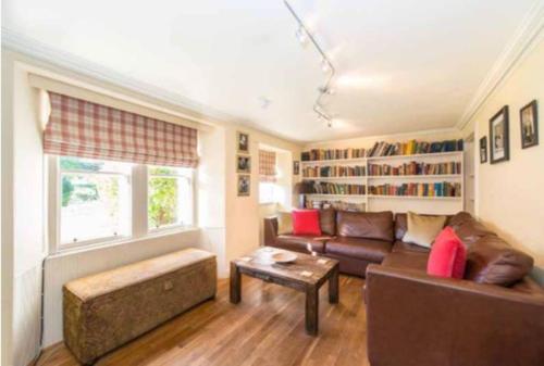 a living room with a couch and a table at Carphin House near St Andrews - Sleeps 18 in Fife