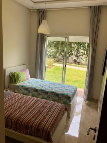 Postel nebo postele na pokoji v ubytování Appartement moderne CASABAY BEACH Sidi Rahal