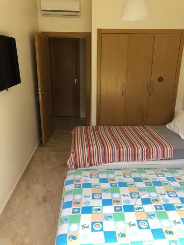 Postel nebo postele na pokoji v ubytování Appartement moderne CASABAY BEACH Sidi Rahal