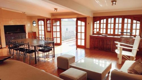 a large living room with a table and a kitchen at Hotel Boutique Casa & Cava in Mendoza