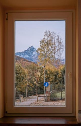 a window with a view of a mountain at Le Ortensie in Paesana