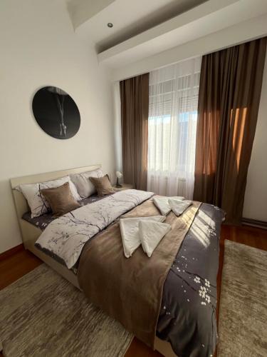 a bedroom with a large bed and a window at Airport SKY apartments LUX II in Belgrade