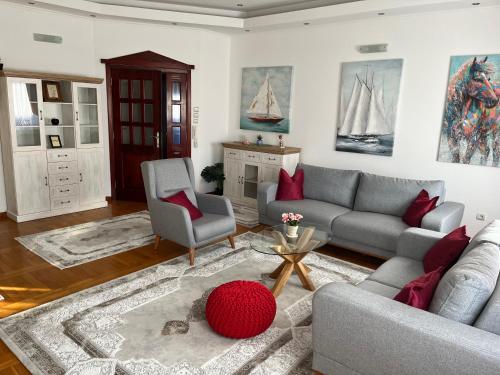 a living room with a couch and two chairs at Airport SKY apartments LUX II in Belgrade