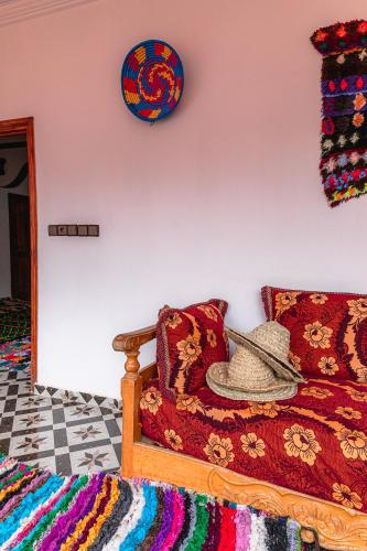 a hat sitting on a couch in a room at Amazigh Family Riad in Imlil