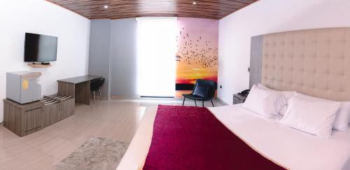 Katil atau katil-katil dalam bilik di Hotel Punta Arena Spa Boutique