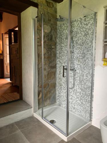 a shower with a glass door in a bathroom at Birillina Guest House di Laura Reni in Poggio