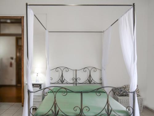 a bed with a canopy in a room at Al Duomo in Enna