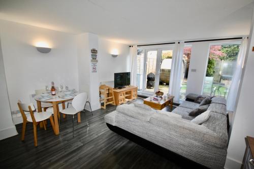 a living room with a couch and a table at Bournemouth Hot Tub & Sauna Holiday Let in Bournemouth