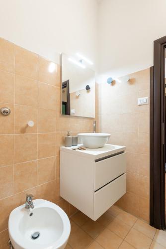 a bathroom with a white sink and a mirror at Maison Camilla Near Train Station in Nettuno