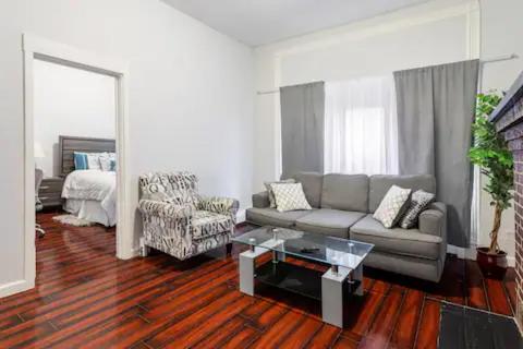 a living room with a couch and a coffee table at CLINTON HILLS - Newark in Newark