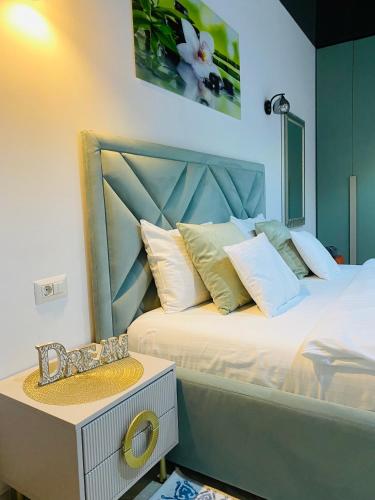a bedroom with two beds with a headboard and a table at Luxury Mamaia Central in Mamaia