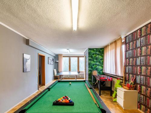 a living room with a pool table and books at Kurhaus am Nordenau - 10 pers in Schmallenberg