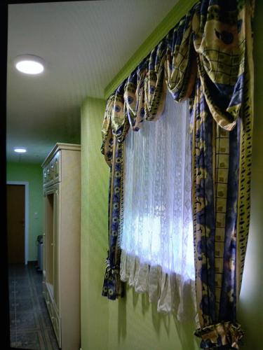 a room with a window with curtains on a wall at Apartman Aleksandar in Banja Luka