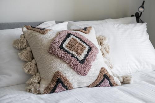 a pillow sitting on top of a bed at Modern studio by Finnoo metro in Espoo