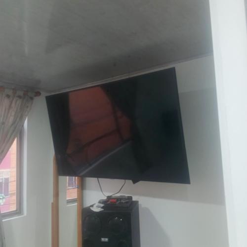 a flat screen tv hanging on a wall at Tres Reyes apto in Soacha