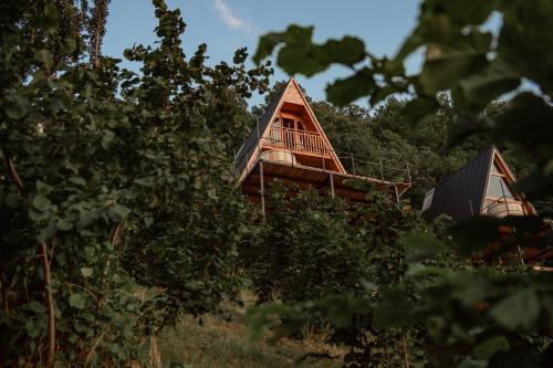 a tree house with a deck in the trees at The overlook cottage 2 in Keda