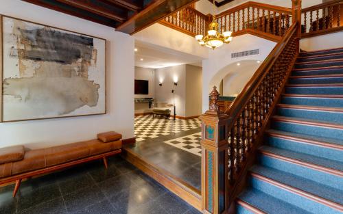 a staircase in a home with a chandelier at El Bodeguero Hotel in Salta