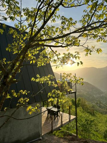 a bench on a wooden deck with a view of the mountains at The overlook cottage 2 in Keda