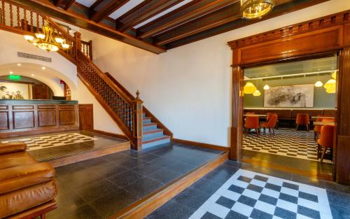a lobby with a staircase and a dining room at El Bodeguero Hotel in Salta