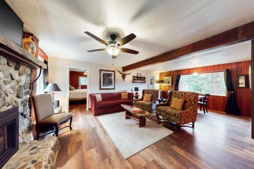 a living room with a couch and a ceiling fan at Honors Nook in Joseph
