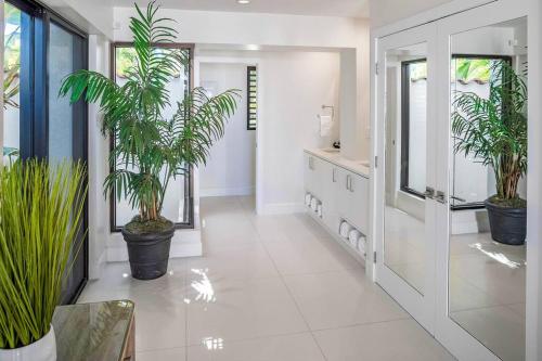 a hallway with potted plants in a house at Casa Grande - Grace Bay Beach in The Bight Settlements
