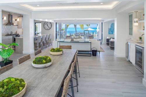 a kitchen and living room with a table and a dining room at Casa Grande - Grace Bay Beach in The Bight Settlements