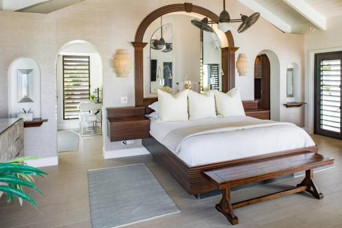 a bedroom with a large bed and a table at Casa Grande - Grace Bay Beach in The Bight Settlements