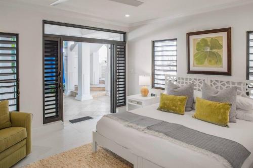 a bedroom with a large bed and a couch at Casa Grande - Grace Bay Beach in The Bight Settlements