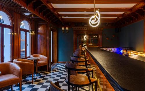 a bar with a row of stools and a long counter at El Bodeguero Hotel in Salta