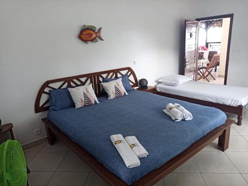 a bedroom with two beds with towels on them at Ô Bleu Azur in Antsatrakolo