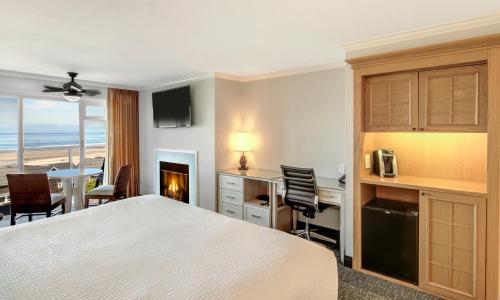 a hotel room with a bed and a desk and a table at Hallmark Resort in Cannon Beach in Cannon Beach