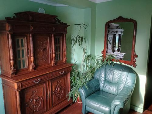 a room with a dresser and a chair and a mirror at Pokoje Złotoryja in Złotoryja