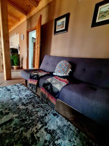 a living room with a blue couch and a couch at Rocky Aloe Escape in Krugersdorp