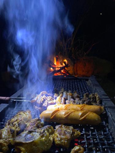 a grill with a bunch of food on it at Dunali Mountains Galaha in Galaha Town