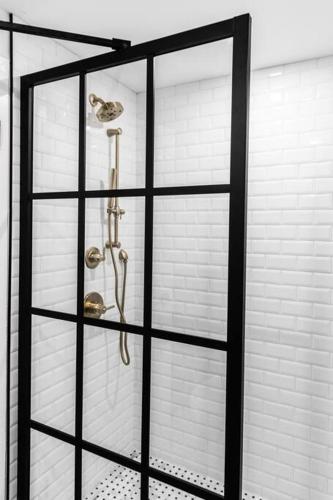 a glass shower door with two pairs of shower heads at King Bed, Fiber Internet, Heart of Bangor, 50 Roku TV, Room # 208 in Bangor