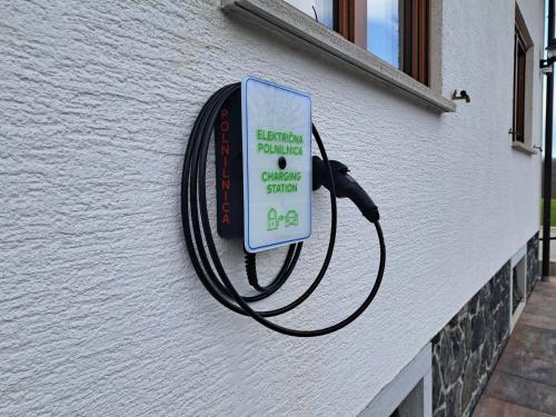 a sign hanging on the side of a building at Holiday Home Toplica Natura with natural thermal Bath in Cerklje ob Krki