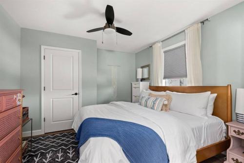 a bedroom with a bed with a ceiling fan at Southbound Stays - Little House in Nashville