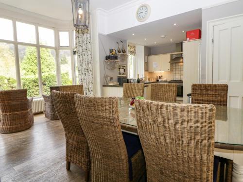 a kitchen with rattan chairs and a table in a room at River Lodge in Ambleside